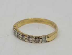 A 18ct. gold seven stone diamond ring, set row of seven round brilliant cut diamonds, size UK N. (