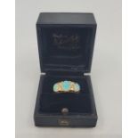 An 18ct. gold, opal and diamond ring, Birmingham 1912, set three graduated oval cabochon opals