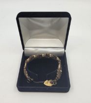 A 9ct. gold gate bracelet, with 9ct. gold heart padlock clasp. (14.6g)