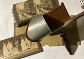 A collection of stereoscope cards and viewer