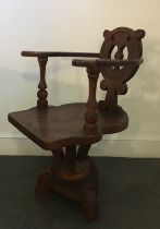 An arts and crafts oak swivel chair