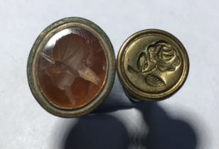 Mixed lot of two 17th-19th Century fob seals. Copper alloy seal fob with an orange glass face