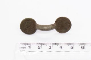 Saxon copper alloy equal arm brooch with circular plates either side. Both plates have four leafed X