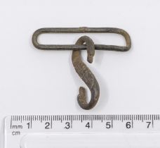 A cast copper alloy, S shaped belt fastener probably of post medieval date, AD 1650 – 1800. It is