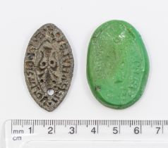 Medieval lead vasica seal featuring a large Fluer-de-lis and inscribing with what is believed to