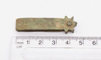 Medieval gilt copper alloy strap end formed from a cast strip folded widthways and secured, at the