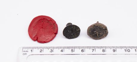 Pair of Medieval copper alloy round faced matrix seals in the chess piece style. One seal depicts