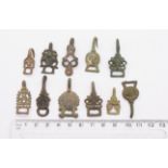 Lot of eleven early post medieval copper alloy dress hooks with differing decorations and sizes,