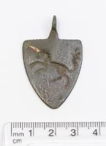 Medieval copper alloy Pendant depicting what appears to be a unicorn as there is still a red/white