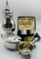 A collection of sterling silver table ware. Including a George V sugar caster of baluster form,