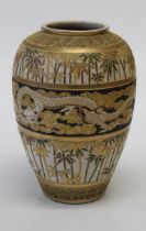 A Japanese earthenware vase, early 20th century. Decorated in gilt, green and ochre with dragons,