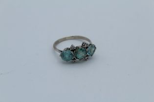 An early 20th century three stone zircon and diamond ring, featuring three bright blue round cut