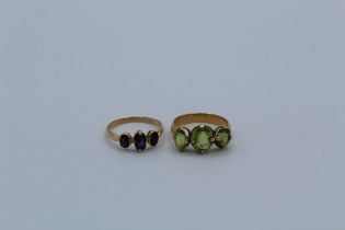 Two rings : A peridot set trilogy ring in yellow metal, testing as 18ct gold, size M, approximate