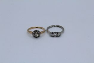 Two early 20th century diamond rings, a diamond cluster daisy ring, stamped18 to the shank, size