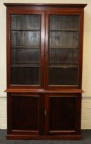 An Edwardian mahogany bookcase cabinet, the moulded cornice over a pair of egg and dart cockbeaded