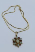 A 9ct yellow gold opal and ruby starburst pendant along with a 9ct gold box chain. Pendant
