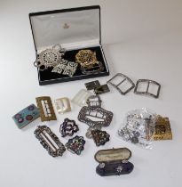 A collection of buckles and buttons. To include a sterling silver nurses belt buckle, in circular