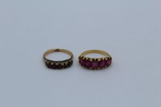 Two ruby set half hoop rings, one, which tests as 18ct gold, is set with five square cut rubies,