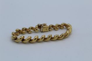 An Italian made curved hollow link bracelet in yellow precious metal. Stamped 14k Italy, the metal