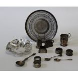 A collection of sterling silver comprising two pierced work dishes, four napkin rings, an unengraved
