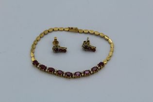 A suite of ruby and white stone set jewellery in precious yellow metal. Testing as 14ct gold,
