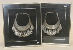 A pair of framed white metal Hmong style wedding necklaces