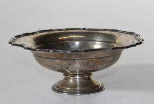 A sterling silver footed dish with pie crust rim, with engraving. Marked for Barker Brothers