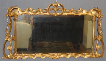 A 19th century Rococo style giltwood overmantel mirror, with an acanthus leaf surmount and s