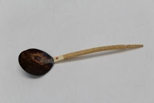 A late 19th / early 20th century Ottoman sherbet spoon, the polished coconut bowl with coral bead to
