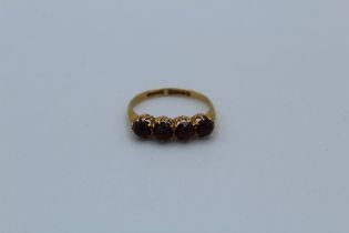 A four stone rose cut garnet dress ring in 18ct yellow gold, size U. Approximate gross weight 4gm