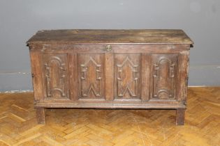 An early 18th century oak four panel coffer, with vacant interior, raised on stile supports, 79 x