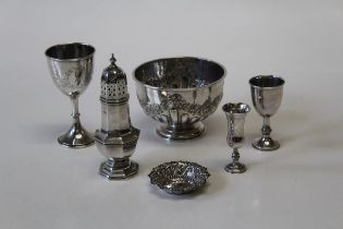 A collection of silver comprising a footed bowl with embossed swags and fluting, indistinct makers