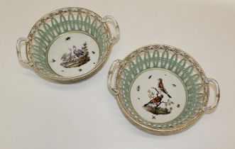 A pair of 19th century German porcelain twin handled chestnut baskets, each finely decorated with
