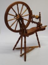 A 20th century beech spinning wheel, of traditional twelve spoke form. Maximum height 90cm An