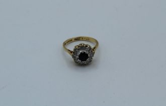 An 18k sapphire and diamond cluster ring. 4.7gm approximately