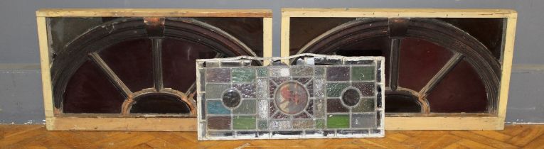 Two stained glass astragal glazed overdoors, in wooden frames, together with a leaded stained
