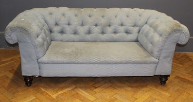 A beech framed two seater Chesterfield settee upholstered in light patterned weave raised on short