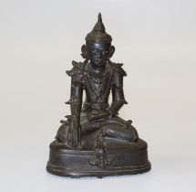 A Thai bronze Buddha, probably late 17th century. Seated in typical pose, with shell eyes and