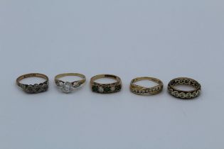 A collection of 9ct gold rings featuring a cubic zirconia solitaire, a diamond three sone antique