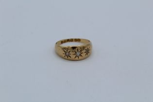 An 18ct gold gypsy set three stone diamond ring, size M, gross weight 3.9gm