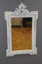 A 19th century carved giltwood, later white painted wall mirror, the stiff leaf and flowerhead