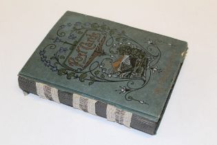 An early 20th century postcard album, containing approximately two hundred and fifty cards,