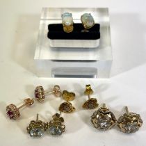 A pair of 18ct gold opal stud earrings along with a collection of four other ear studs. The opal