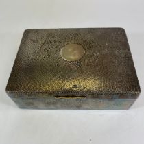 An Edward VII large sterling silver wooden lined cigar box. With hammered surface. The lid is heavy