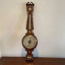 A Regency mother of pearl inlaid rosewood barometer with hydrometer above thermometer and dial.