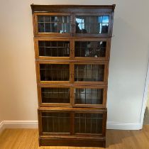 An oak stacking five section bookcase with leaded glazed doors. Approximately 88cm by 31cm deep at