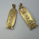 Two Egyptian cartouche pendants with hieroglyphs depicting the names "Susan" and "Norman" each. Both