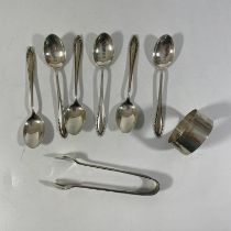 A silver napkin ring, six silver coffee spoons and a silver nip. Total weight approximately 106