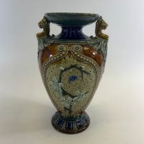 A twin handle blue and brown glazed Doulton Lambeth vase no 1884 by John Broad. Approximately 28cm