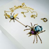 A paste set spider and fly necklace. In precious yellow metal stamped "9ct" and testing as 9ct gold.